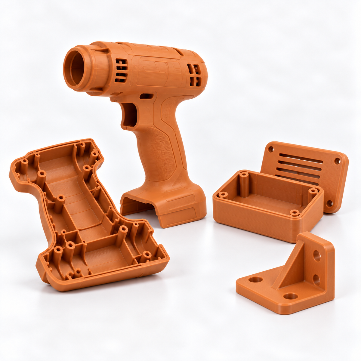 BALSAM ABS warm orange filament spool, 1.75 mm, 1 kg, beside matching 3D-printed power tool housing prototypes.